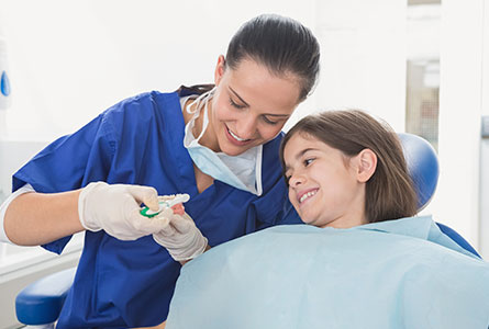Kid and hygienist at the dental office